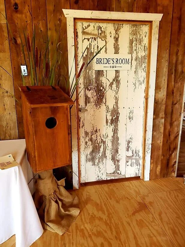 Rustic whitewashed Bride's Room door at the Wisconsin wedding barn dressing room