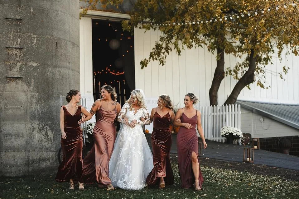 Bridal party in front of the wedding barn and silo at Huser Farm in Wisconsin