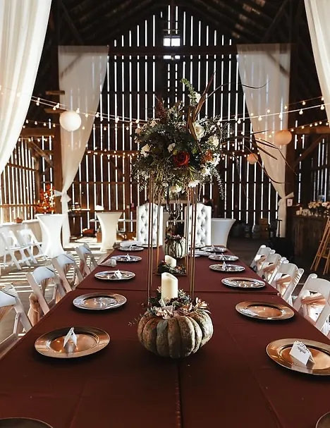 Beautiful wedding reception hall set for dinner in the rustic Wisconsin wedding barn
